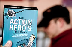 hand holding up Action Hero's Handbook
