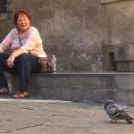 Karen watching pigeons in Siena