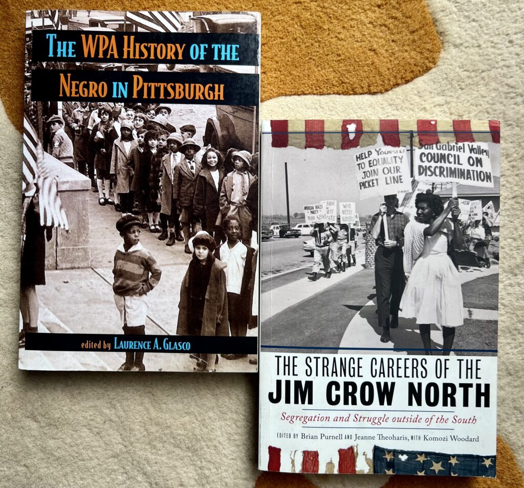 Two books about Black history in Pittsburgh, Pennsylvania and during the Jim Crow Era throughout the North. Left is "The WPA History of the Negro in Pittsburgh." Right is "The Strange Careers of the Jim Crow North"