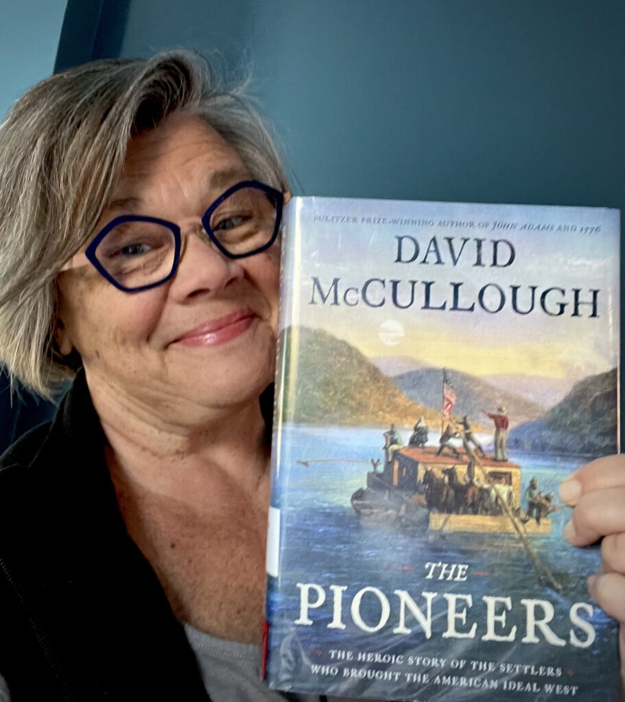 Tamela holding David McCullough's book, "The Pioneers" about the white settlers of the first Ohio town, Marietta