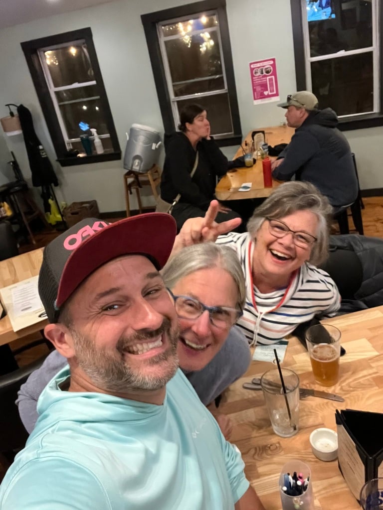 Three people at a bar table