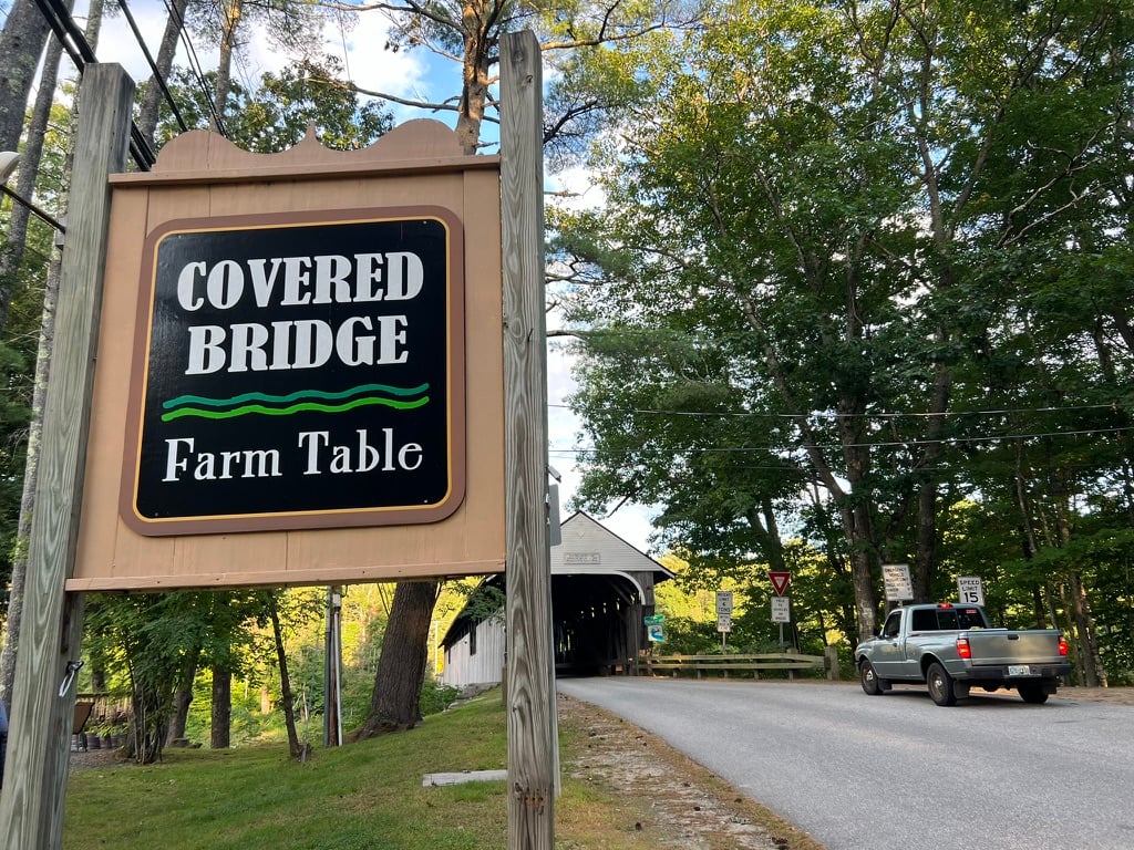 sign leading to a covered bridge