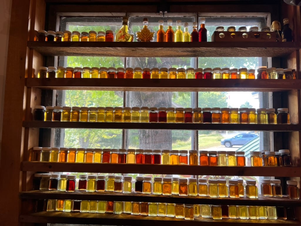 jars and bottles of maple syrup in a window